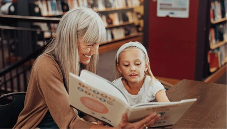 grandmother-reading-book-girl-library-260nw-2753252701